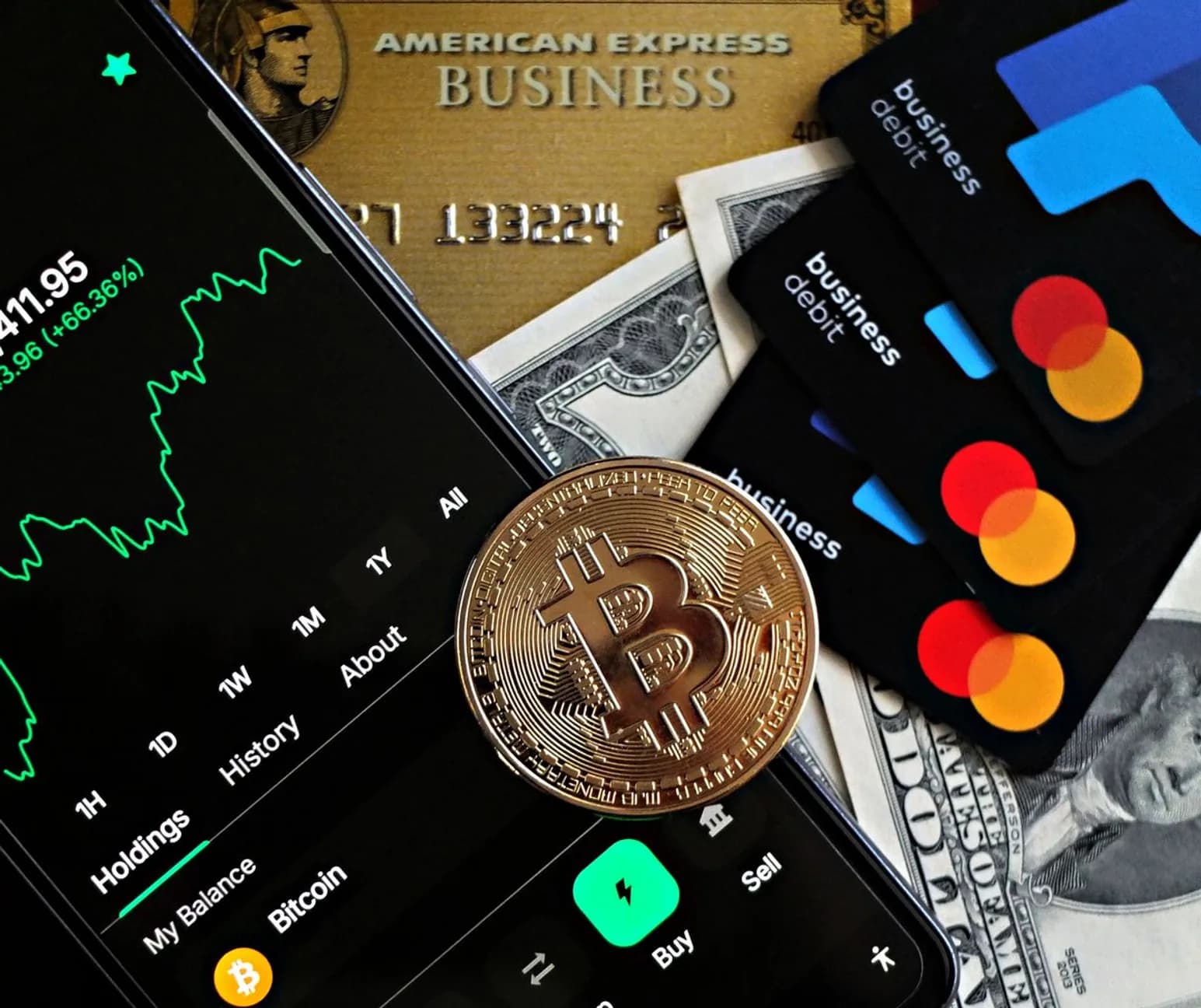 FinTech assets including a mobile crypto trading app, payment cards, and currency representing digital and traditional finance